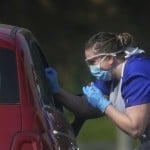 A Nhs Worker Is Tested For Coronavirus At A Temporary Drive Through Testing Station In The Car Park Of Chessington World Of Adventures In Chessington, England, Saturday March 28, 2020