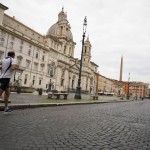 A Man Runs In Rome's Piazza Navona Square, Two And Half Weeks Into A National Lockdown To Contain The Spread Of The Covid 19 Virus, In Rome, Saturday, March 28, 2020.