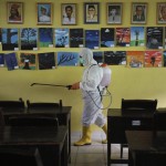A Member Of Indonesian Red Cross Sprays Disinfectant In The Wake Of The Coronavirus Outbreak In A Class Room At A School In Jakarta, Indonesia, March 16, 2020