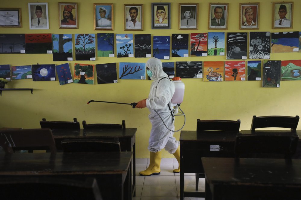 A Member Of Indonesian Red Cross Sprays Disinfectant In The Wake Of The Coronavirus Outbreak In A Class Room At A School In Jakarta, Indonesia, March 16, 2020