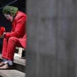 David Vazquez, A Street Performer Dressed As The Joker, Waits In Hopes Of Pedestrians Who Will Pay To Take Pictures With Him In Mexico City, March 23, 2020.