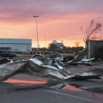 Debris Covers A Parking Lot As The Sun Sets After A Tornado In Jonesboro, Ark., Saturday, March 28