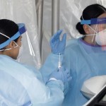 Medical Staff In Protective Gear Administer A Test For Covid 19 At A Drive Through Testing Center In Paramus, N.j., Friday, March 20,