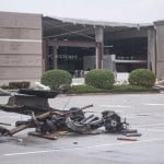 The Damaged Remains Of A Vehicle Lie In A Parking Lot In Front Of A Damaged Ashley Homestore After A Tornado Stuck Saturday, March 28