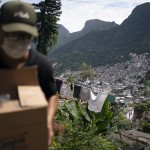 Local Volunteer Carries A Package With Soap And Detergent To Be Distributed In An Effort To Stop The Spread Of The New Coronavirus In The Rocinha Slum Of Rio De Janeiro, Brazil, March 24, 2020