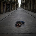 A Man Sleeps In An Empty Street During The Coronavirus Outbreak In Barcelona