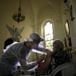 A Medical Worker Injects An Elderly Woman With A Flu Vaccine Inside A Church As Part Of A Government Vaccination Campaign, In Buenos Aires, Argentina,