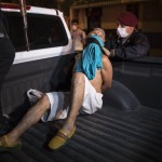 A Police Officer Adjusts A T Shirt As A Protective Mask For A Man They Detained For Violating The Curfew Amid Coronavirus Concerns In El Callao, On The Outskirts Of Lima, Peru