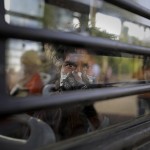 An Indian Homeless Man Sits In A Bus As He Is Being Evicted With Other Homeless People