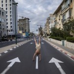 An Israeli Man Stands On His Hands On An Empty Road During A Lockdown Following Government Measures To Help Stop The Spread Of The Coronavirus, In Tel Aviv, Israel