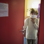 Jacqueline Huber Wears A Face Mask As She Looks Out From A Doorway At A Care Home In Kaysesberg, France April 16, 2020.