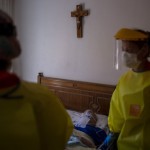 Medical Workers Making An Emergency Home Visit Walk Away From A Man, Moments After They Confirmed He Died Of Severe Respiratory Problems In Barcelona, Spain, April 6, 2020