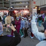 Medical Workers Pose For Photographs As Police Officers And Pedestrians Cheer For Them Outside Nyu Medical Center