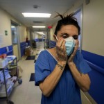 Nurse Cristina Settembrese Fixes Two Masks To Her Face During Her Work Shift In The Covid 19 Ward At The San Paolo Hospital In Milan, Italy, April 10, 2020.