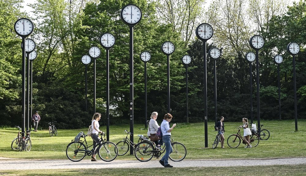 People With Bicycles Meet At The Clock Park In Duesseldorf, Germany