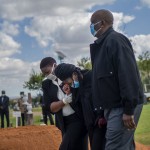 Relatives Grieve Benedict Somi Vilakasi At His Burial Ceremony At The Nasrec Memorial Park Outside Johannesburg