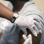 Sisi Ndebele, Receives A Seasonal Influenza Vaccine From A Nurse At A Local Pharmacy Clinic In Johannesburg, South Africa