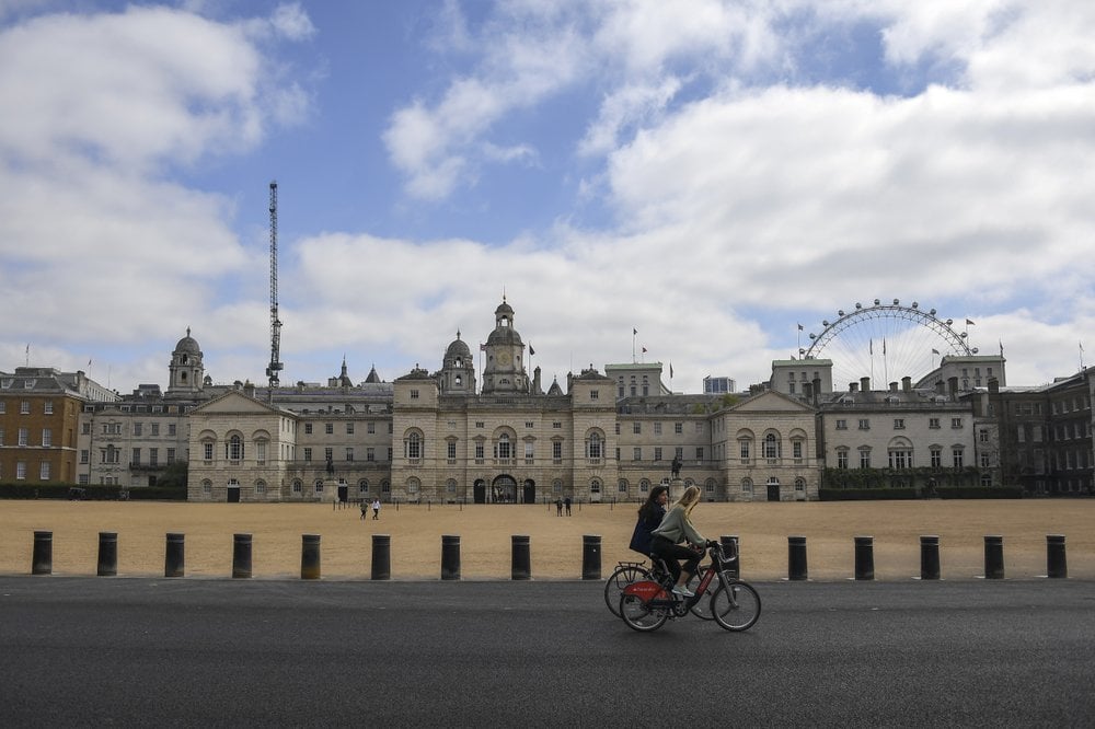 Two Women Ride Bicycles Past The Horse Guards Parade, During Lockdown Due To The Coronavirus Outbreak, In London