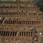 Cemetery Workers Wearing Protective Clothing As A Measure Against The Spread Of The Novel Coronavirus