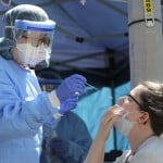 Nurse Using Nose Swab On Patient In Seattle's International District