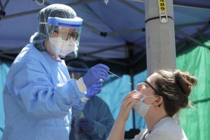 Nurse Using Nose Swab On Patient In Seattle's International District