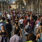 People Exercise On A Seafront Promenade In This Photo Taken With A Telephoto Lens In Barcelona, Spain