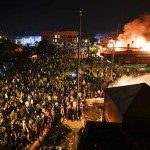 Protestors Demonstrate Outside Of A Burning Minneapolis 3rd Police Precinct, Thursday, May 28