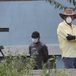 Residents, Wearing Protective Face Masks And Gloves, Watch As Journalists Arrive In Their Neighborhood To Confirm The Death Of A Neighbor Who Allegedly Died Of The New Coronavirus
