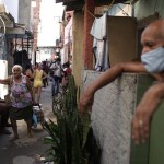An Elderly Woman Pulls A Grocery Caddy Filled With Food Donated By A Non Governmental Agency Amid The The New Coronavirus Pandemic