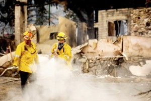 A Los Angeles County Firefighter Extinguishes Hot Spots At A Scorched Residence While Battling The Lake Fire In The Angeles National Forest, Calif.,
