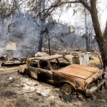 A Burned Vehicle Rests Along Pine Canyon Rd. As The Lake Fire Burns In The Angeles National Forest, Calif., North Of Santa Clarita