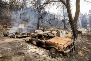 A Burned Vehicle Rests Along Pine Canyon Rd. As The Lake Fire Burns In The Angeles National Forest, Calif., North Of Santa Clarita