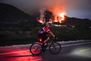 A Cyclist Rides Along A Trail As The Ranch Fire Burns, Thursday, Aug. 13, 2020, In Azusa, Calif