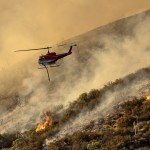 A Helicopter Prepares To Drop Water On The Lake Fire Burning In The Angeles National Forest North Of Santa Clarita, Calif.