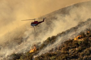 A Helicopter Prepares To Drop Water On The Lake Fire Burning In The Angeles National Forest North Of Santa Clarita, Calif.