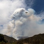 A Super Scooper Water Dropping Aircraft Passes A Plume Of Smoke As The Lake Fire Burns In The Angeles National Forest North Of Santa Clarita, Calif