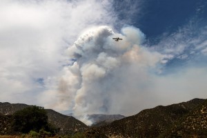 A Super Scooper Water Dropping Aircraft Passes A Plume Of Smoke As The Lake Fire Burns In The Angeles National Forest North Of Santa Clarita, Calif