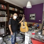 Alain Shoucair, 38, Poses For A Photograph As He Holds His Broken Guitar At His Destroyed Apartment After Tuesday's Explosion