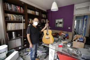 Alain Shoucair, 38, Poses For A Photograph As He Holds His Broken Guitar At His Destroyed Apartment After Tuesday's Explosion