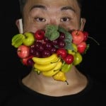 Edmond Kok, A Hong Kong Theater Costume Designer And Actor, Wearing A Face Mask Decorated With Many Different Fruits In Hong Kong