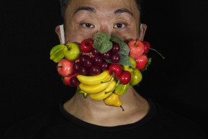 Edmond Kok, A Hong Kong Theater Costume Designer And Actor, Wearing A Face Mask Decorated With Many Different Fruits In Hong Kong