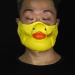 Edmond Kok, A Hong Kong Theater Costume Designer And Actor, Wearing A Face Mask Made By A Rubber Yellow Duck In Hong Kong