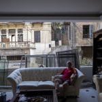 George Abdo, 58, Poses For A Photograph Inside His Destroyed Apartment After Tuesday's Explosion