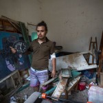 Hasan Al Armali, Holds A Wall Clock That Was Stoped Working At The Time Of The Tuesday's Explosion In The Seaport Of Beirut, Poses For A Photograph At His Bedroom Inside His Destroyed Apartment