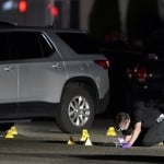 A Washington State Patrol Crime Lab Worker Looks At Evidence Markers In The Early Morning Hours Of Friday