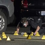 A Washington State Patrol Crime Lab Worker Looks At Evidence Markers In The Early Morning Hours Of Friday 3