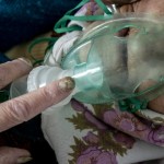 An Elderly Woman, A Patient With Coronavirus, Breaths With An Oxygen Mask Inside A Hospital In Pochaiv, Ukraine