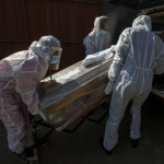 Funeral Home Workers In Protective Suits Carry The Coffin Of A Woman Who Died From Covid 19 Into A Hearse In Katlehong, Near Johannesburg, South Africa