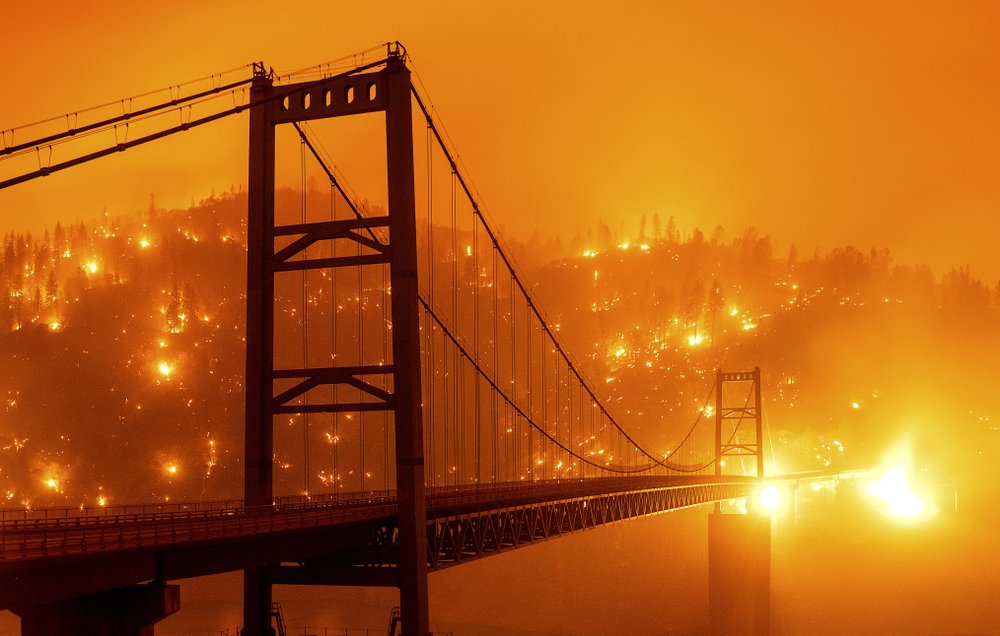 In This Image Taken With A Slow Shutter Speed, Embers Light Up A Hillside Behind The Bidwell Bar Bridge As The Bear Fire Burns In Oroville, Calif