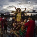 Indian Hindu Devotees Prepare To Immerse An Idol Of Goddess Durga In The River Hooghly